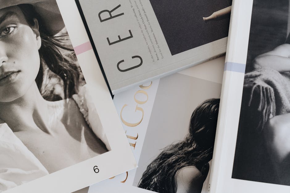 A close-up view of artistic and fashion magazines laid out on a table.